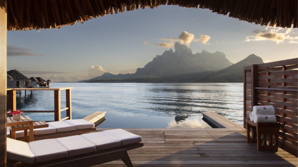 Lounge chair overlooking the mountains and ocean from a private room at Four Seasons Resort Bora Bora