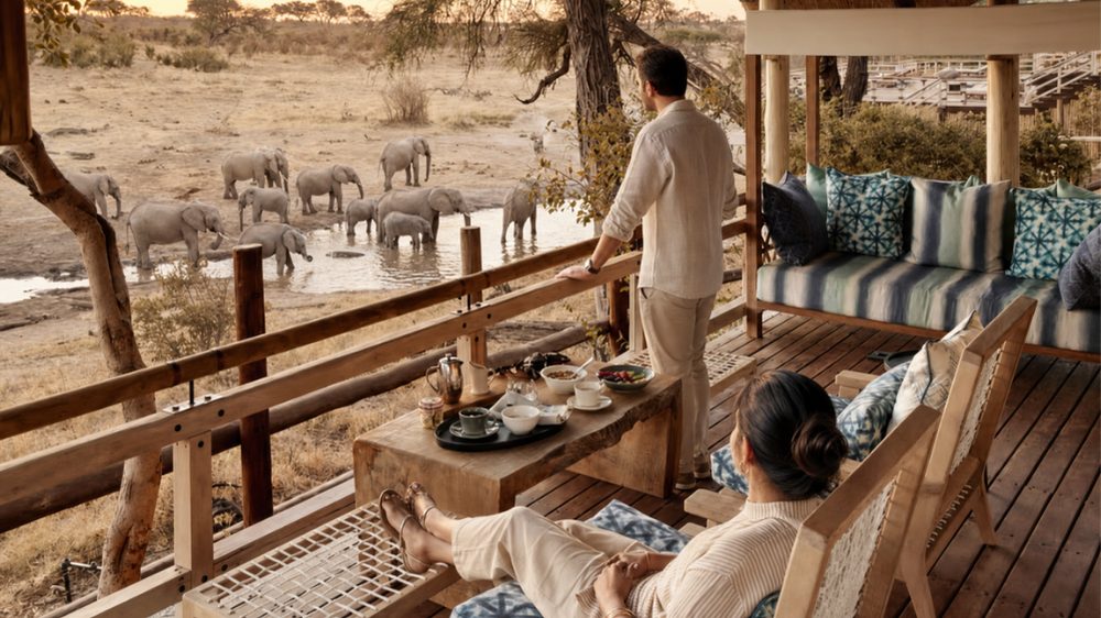 Wild elephant viewed from the deck of a luxury tented room at Belmond Savute Elephant Lodge in Botswana